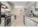 Well-lit kitchen featuring granite countertops, stainless steel appliances, and ample cabinet space at 2550 N Alafaya Trl # 2304, Orlando, FL 32826