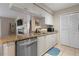 Open concept kitchen with granite countertops, stainless steel appliances, and white cabinets at 2550 N Alafaya Trl # 2304, Orlando, FL 32826