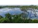 Picturesque lake view featuring tranquil waters and lush tree lined shores at 2550 N Alafaya Trl # 2304, Orlando, FL 32826
