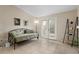 Bright living room featuring a neutral color palette, tile flooring, and a glass sliding door at 2550 N Alafaya Trl # 2304, Orlando, FL 32826