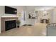 View of the living area into the kitchen, with tile floors, neutral colors, and a fireplace at 2550 N Alafaya Trl # 2304, Orlando, FL 32826
