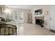 View of the living room and fireplace, with lots of natural light, neutral tile, and glass doors to the patio at 2550 N Alafaya Trl # 2304, Orlando, FL 32826