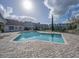 Resort-style community pool with brick pavers and inviting lounge chairs for relaxation at 2550 N Alafaya Trl # 2304, Orlando, FL 32826