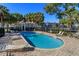 Inviting community pool surrounded by lounge chairs and lush palm trees on a sunny day at 2550 N Alafaya Trl # 2304, Orlando, FL 32826