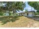 Expansive backyard features mature trees and ample space for outdoor activities and relaxation at 2710 W County Road 44, Eustis, FL 32726