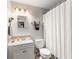 Bathroom featuring a shower with a curtain, a sink and mirror at 2710 W County Road 44, Eustis, FL 32726