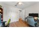 Bedroom featuring hard wood floors, a ceiling fan, closet and a desk set-up at 2710 W County Road 44, Eustis, FL 32726