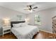 Bright bedroom featuring a ceiling fan, hardwood floors and natural light from two windows at 2710 W County Road 44, Eustis, FL 32726