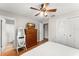 Bedroom featuring hard wood floors, ceiling fan, a closet, and a bathroom at 2710 W County Road 44, Eustis, FL 32726