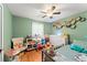 Well-decorated bedroom featuring a ceiling fan, hardwood floors and a window at 2710 W County Road 44, Eustis, FL 32726
