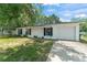 Charming home with a well-maintained front yard and an attached garage at 2710 W County Road 44, Eustis, FL 32726