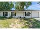Charming single-story home featuring a white exterior, black shutters, and well-maintained landscaping at 2710 W County Road 44, Eustis, FL 32726