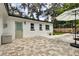 Backyard with stone patio, lush green lawn, and well-maintained landscaping at 280 E Bay Ave, Longwood, FL 32750