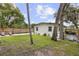 Large backyard showcasing lush greenery, mature trees, and privacy fencing at 280 E Bay Ave, Longwood, FL 32750