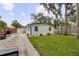 Spacious backyard featuring lush lawn, stone accents, and a private fenced yard at 280 E Bay Ave, Longwood, FL 32750