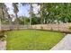 Landscaped backyard with a privacy fence, mature trees, and a well-manicured lawn at 280 E Bay Ave, Longwood, FL 32750