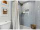Modern bathroom featuring a tiled shower with a rainfall showerhead and a hexagon tiled floor at 280 E Bay Ave, Longwood, FL 32750
