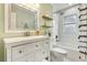Bright bathroom with white subway tile, floating shelves, and modern fixtures at 280 E Bay Ave, Longwood, FL 32750