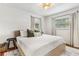 Inviting bedroom with a king bed, soft rug and natural light streaming through the window blinds at 280 E Bay Ave, Longwood, FL 32750