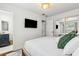 Comfortable bedroom featuring a wall-mounted TV and ample natural light for a relaxing atmosphere at 280 E Bay Ave, Longwood, FL 32750