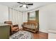 Cozy Bedroom with hardwood floors, a stylish rug, and a wooden crib, perfect for your little one at 280 E Bay Ave, Longwood, FL 32750