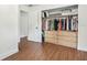 Spacious walk-in closet with custom built-ins and wood floors for optimal storage at 280 E Bay Ave, Longwood, FL 32750