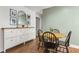 Cozy dining room with light wood floors, complemented by stylish wall decor and seating for four at 280 E Bay Ave, Longwood, FL 32750