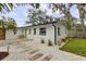 Exterior view of the home showcasing a clean design, a patio, and lush landscaping at 280 E Bay Ave, Longwood, FL 32750