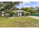 Home's attractive front exterior has landscaping and a carport at 280 E Bay Ave, Longwood, FL 32750