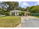 Charming single-story home with a well-manicured lawn and a covered carport at 280 E Bay Ave, Longwood, FL 32750