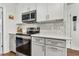 Updated kitchen featuring stainless steel appliances, white cabinets and gray quartz counters at 280 E Bay Ave, Longwood, FL 32750