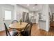 Bright kitchen with stainless steel appliances, dining table and access to backyard at 280 E Bay Ave, Longwood, FL 32750