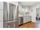 Bright kitchen with stainless steel appliances, modern gray cabinets, and durable wood-look floors at 280 E Bay Ave, Longwood, FL 32750