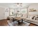 Inviting living room featuring a large sectional sofa, ceiling fan, and hardwood floors at 280 E Bay Ave, Longwood, FL 32750