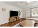 Comfortable living room with a television, mounted mirror, and hardwood floors at 280 E Bay Ave, Longwood, FL 32750