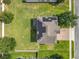 Aerial view of the home with solar panels, landscaping, and a well-maintained lawn at 3184 Pinenut Dr, Apopka, FL 32712