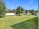 Expansive backyard featuring well-maintained lawn, mature trees, and a privacy fence at 3184 Pinenut Dr, Apopka, FL 32712