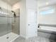 Bright bathroom featuring tiled shower with glass door, tub and window for natural light at 3184 Pinenut Dr, Apopka, FL 32712