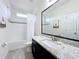 Bright bathroom boasts a black framed mirror and tiled shower with a white curtain at 3184 Pinenut Dr, Apopka, FL 32712