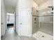 Bathroom showcasing tiled shower with glass door and neutral tile flooring at 3184 Pinenut Dr, Apopka, FL 32712