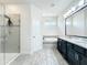 Elegant bathroom with a glass shower, soaking tub, double vanity, and stylish fixtures for a spa-like experience at 3184 Pinenut Dr, Apopka, FL 32712