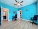 Bright bedroom with blue walls, a ceiling fan, closet, and wood-look flooring at 3184 Pinenut Dr, Apopka, FL 32712