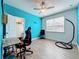 Vibrant bedroom with blue accent wall, ceiling fan, closet, and natural light from window at 3184 Pinenut Dr, Apopka, FL 32712