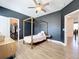 Bedroom featuring a stylish four-poster bed, closet, ceiling fan, and wood-look flooring at 3184 Pinenut Dr, Apopka, FL 32712