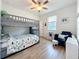 Bedroom featuring bunk bed, closet, ceiling fan, window and blue chair at 3184 Pinenut Dr, Apopka, FL 32712