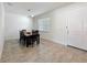 Inviting dining area offers sleek tile floors and a window providing natural light, adjacent to a white door at 3184 Pinenut Dr, Apopka, FL 32712
