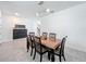 Cozy dining room with tile floors, a modern light, a dark wooden table, and a stylish black cabinet at 3184 Pinenut Dr, Apopka, FL 32712