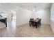 Bright dining area features tile floors, a modern light fixture, and plenty of natural light from the large window at 3184 Pinenut Dr, Apopka, FL 32712
