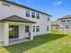Exterior of home features a well-manicured lawn and back patio at 3184 Pinenut Dr, Apopka, FL 32712