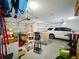 Spacious two car garage features a white car and organized storage at 3184 Pinenut Dr, Apopka, FL 32712